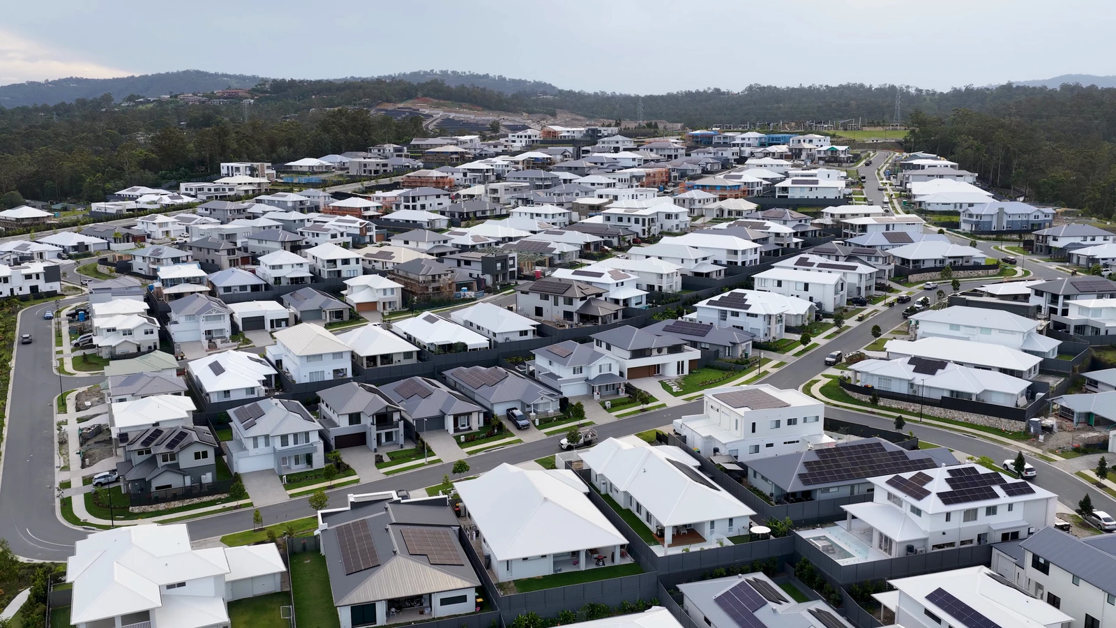 Aerial view of a contemporary residential community with houses, streets and green spaces